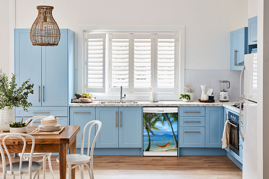 Breakfast table in kitchen with white walls, blue cabinets, marble countertop large window over sink area beach hammock magnet skin on dishwasher white control panel