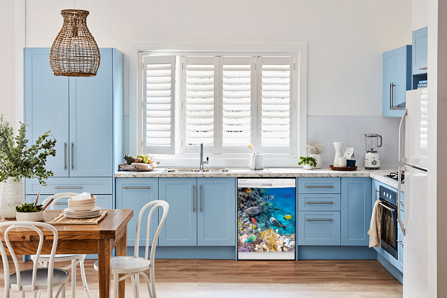  Breakfast table in kitchen with white walls, blue cabinets, marble countertop large window over sink area coral reef fish magnet skin on dishwasher white control panel 