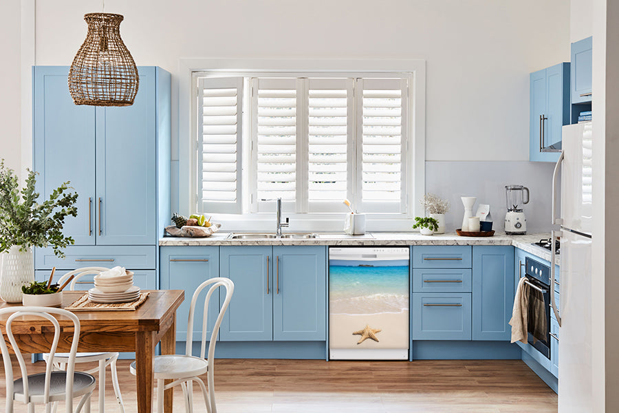  Breakfast table in kitchen with white walls, blue cabinets, marble countertop large window over sink area starfish on beach magnet skin on dishwasher white control panel 