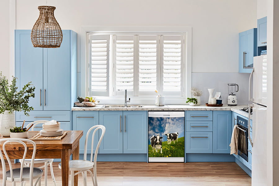 Breakfast table in kitchen with white walls, blue cabinets, marble countertop large window over sink area grazing cows magnet skin on dishwasher white control panel