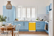 Load image into Gallery viewer, Breakfast table in kitchen with white walls, blue cabinets, marble countertop large window over sink area school bus yellow magnet skin on dishwasher white control panel
