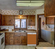 Load image into Gallery viewer, Kitchen Brown Wood Cabinets Recessed Stove &amp; Oven Metal Copper Magnet Skin on Dishwasher White Control Panel Next to Sink
