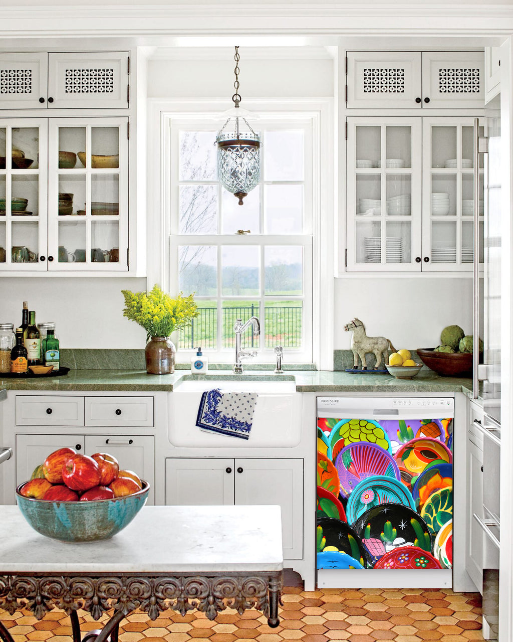 Kitchen with White Cabinets Green Countertop Terra Cotta Floor Kitchen Sink with Window next to Colorful Plates Magnet Skin on Dishwasher with White Control Panel