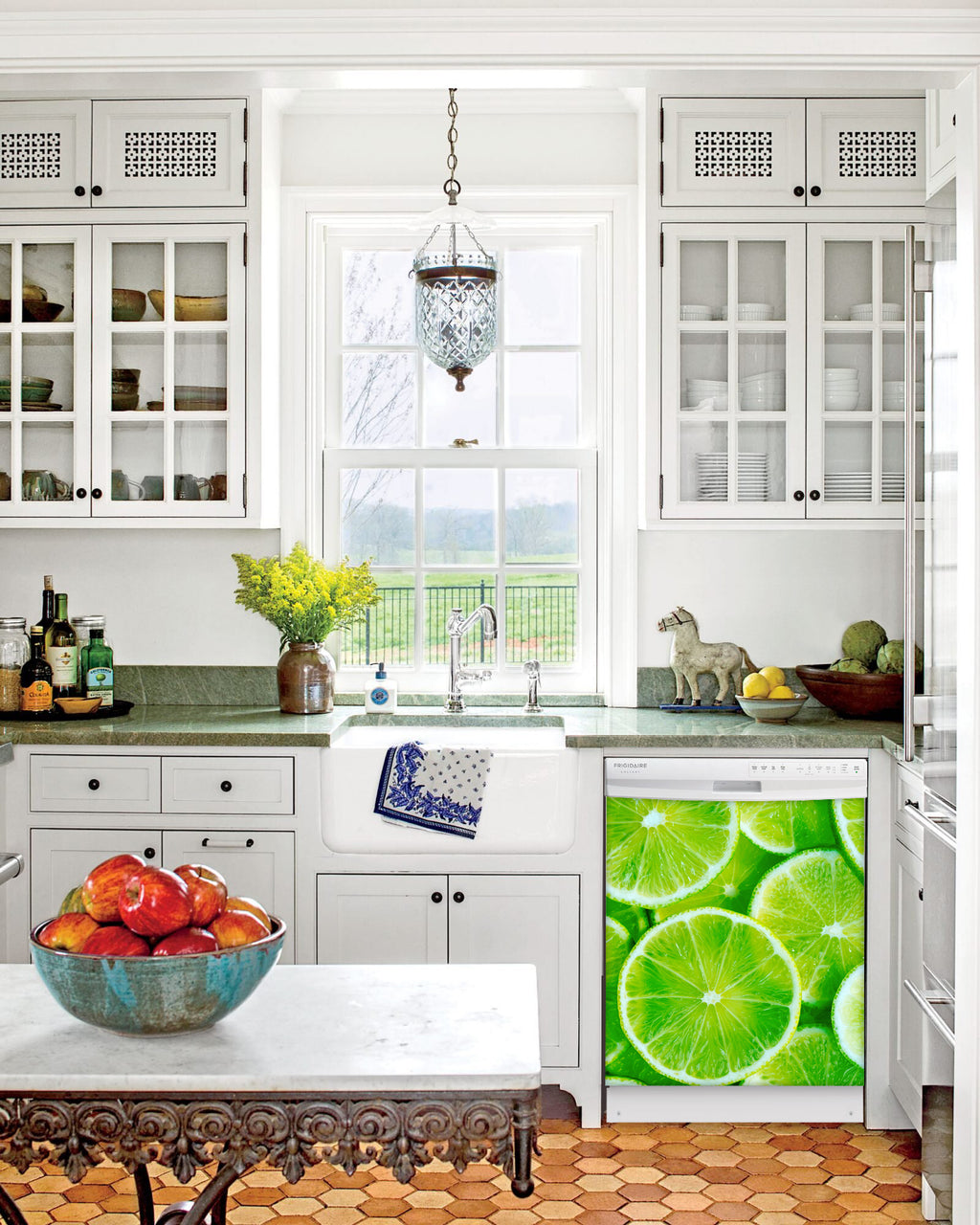 Kitchen with White Cabinets Green Countertop Terra Cotta Floor Kitchen Sink with Window next to Fresh Limes Magnet Skin on Dishwasher with White Control Panel