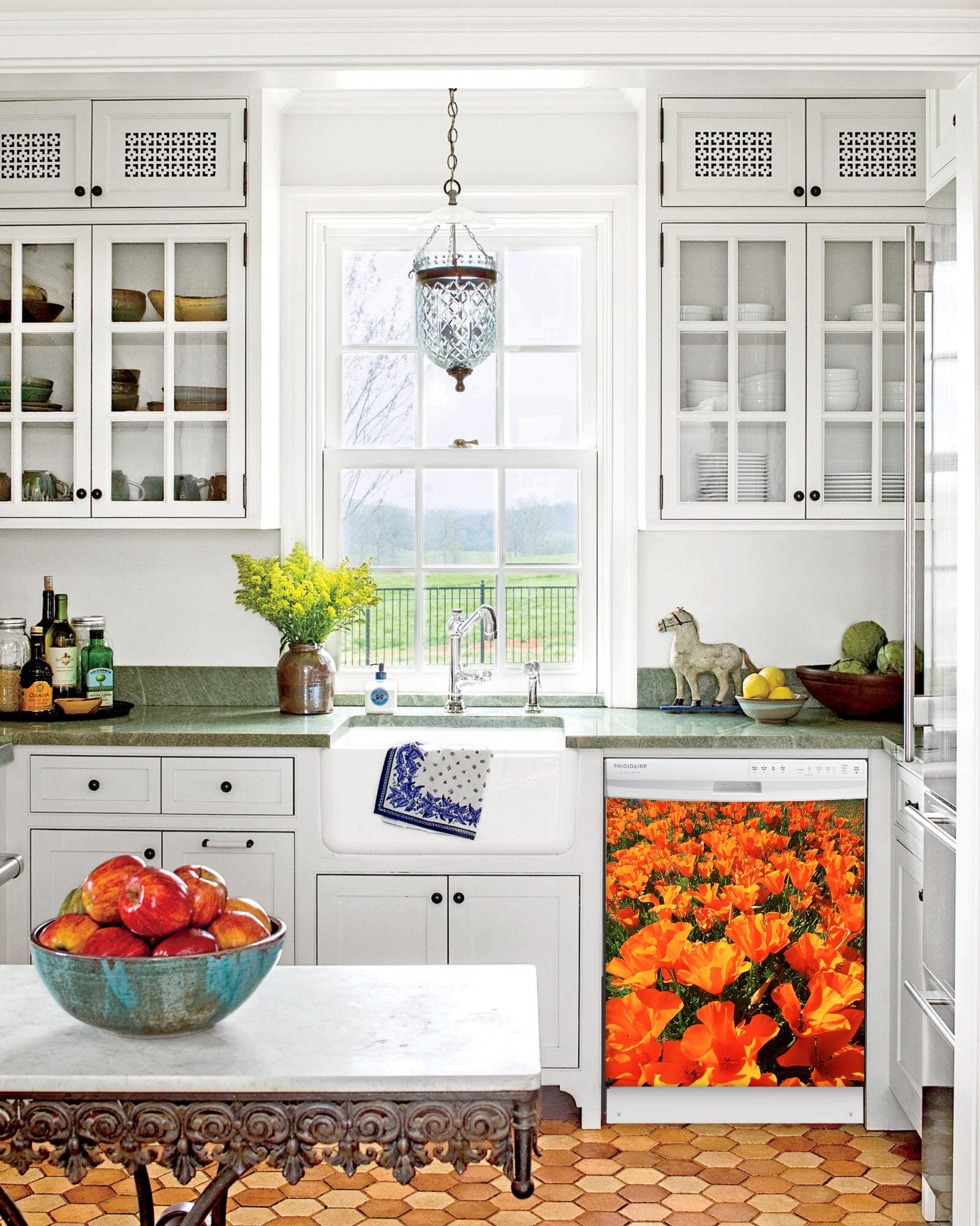 Kitchen with White Cabinets Green Countertop Terra Cotta Floor Kitchen Sink with Window next to Orange Poppies Magnet Skin on Dishwasher with White Control Panel
