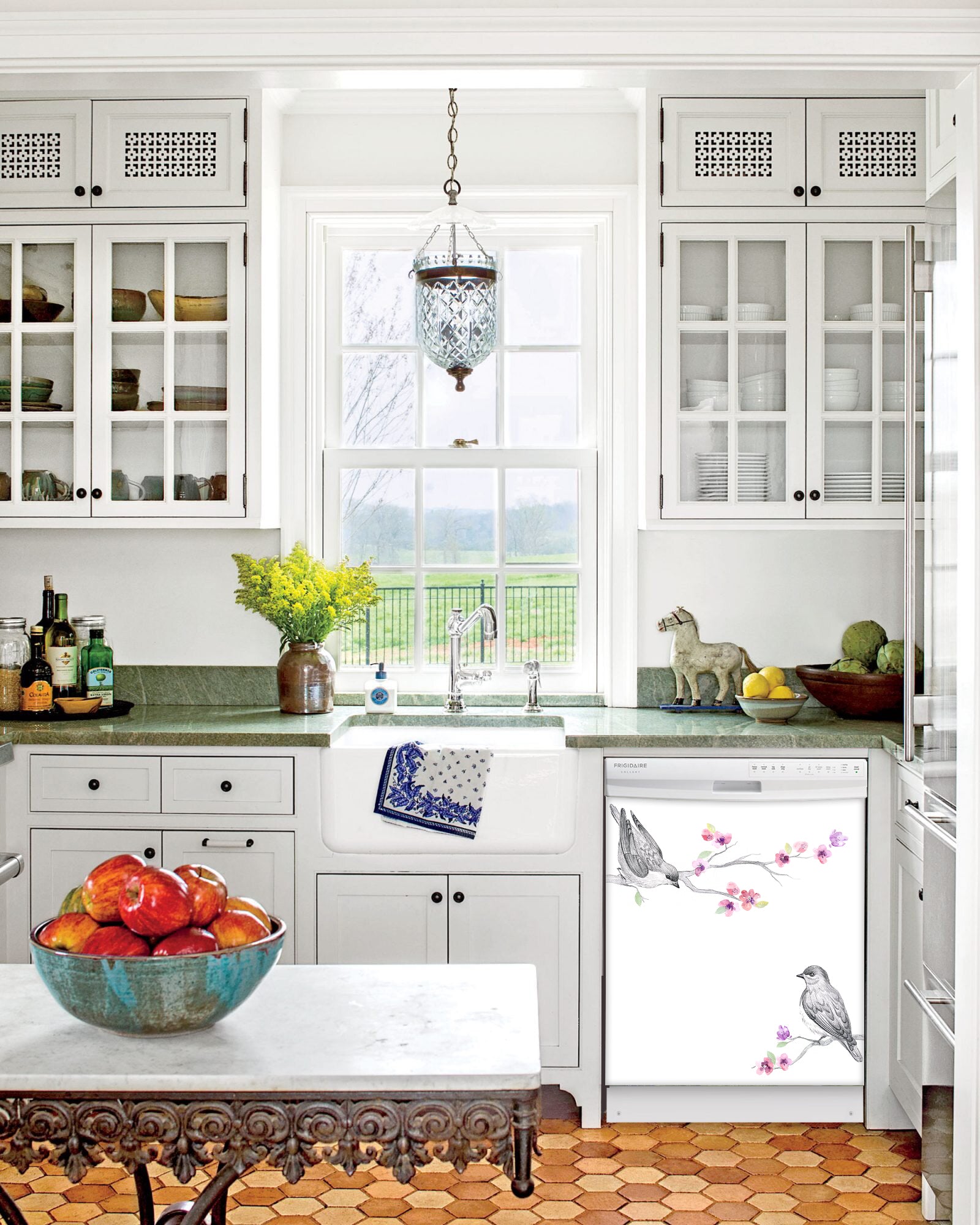 Kitchen with White Cabinets Green Countertop Terra Cotta Floor Kitchen Sink with Window next to Song Birds Magnet Skin on Dishwasher with White Control Panel
