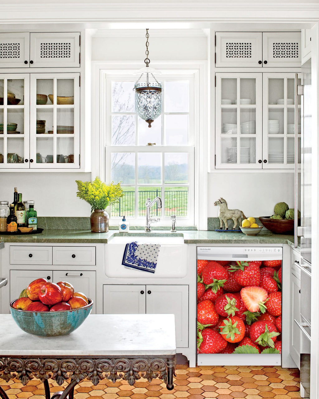 Kitchen with White Cabinets Green Countertop Terra Cotta Floor Kitchen Sink with Window next to Sweet Strawberries Magnet Skin on Dishwasher with White Control Panel