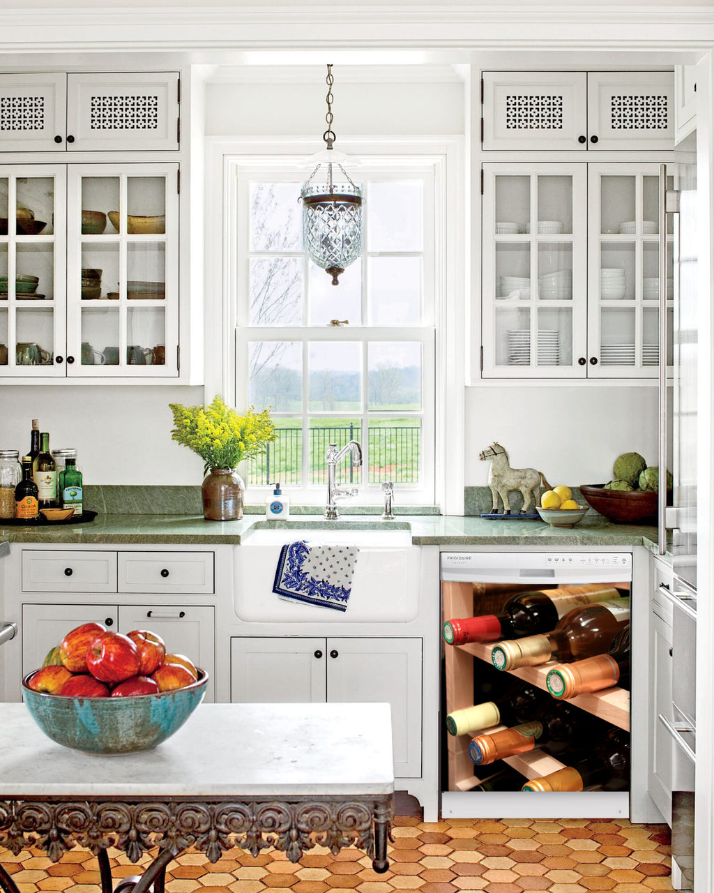 Kitchen with White Cabinets Green Countertop Terra Cotta Floor Kitchen Sink with Window next to Wine Rack Magnet Skin on Dishwasher with White Control Panel